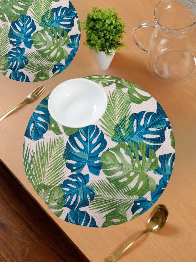 Round tropical leaf-print table mat in blue and green shades