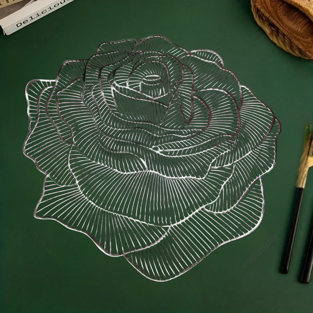 Rose-shaped metallic silver placemat on a green surface, with chopsticks placed beside it.
