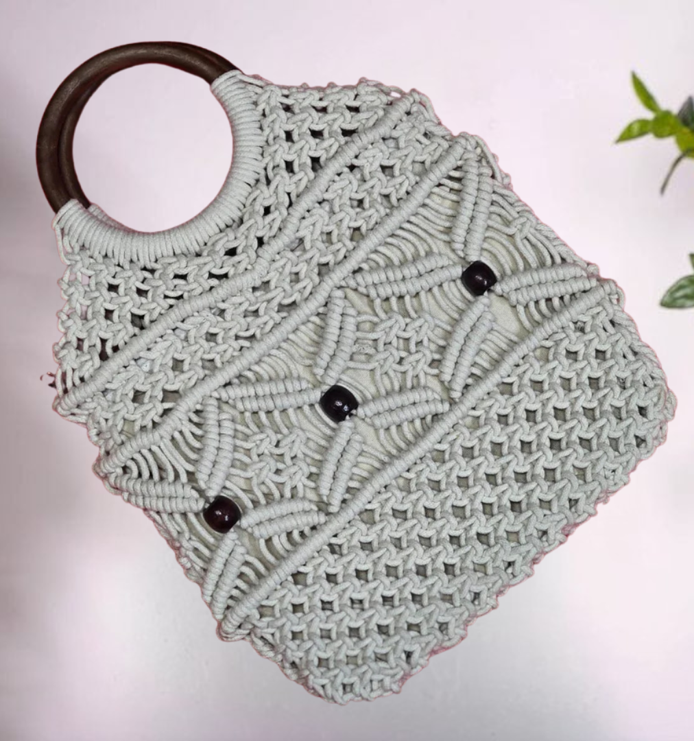 tylish handmade bag with detailed macramé knots and fringe finish.