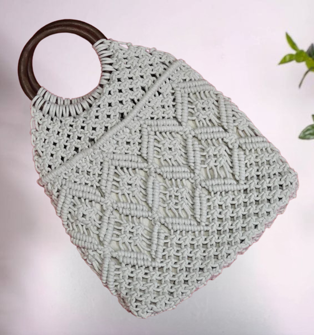 Natural cotton macramé handbag featuring intricate knotted patterns.