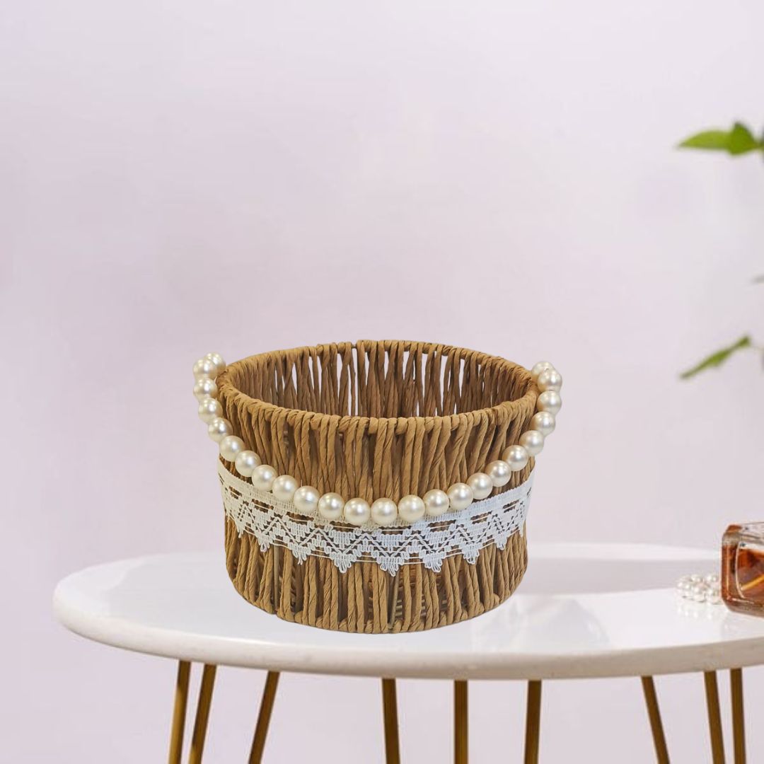 Handwoven raffia basket featuring a white bead handle.