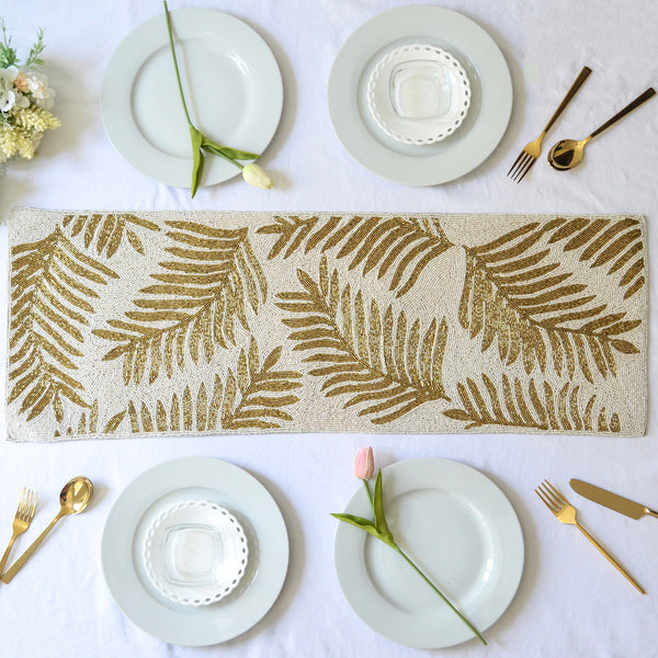 White Floral beaded table runner with plates and spoons on table