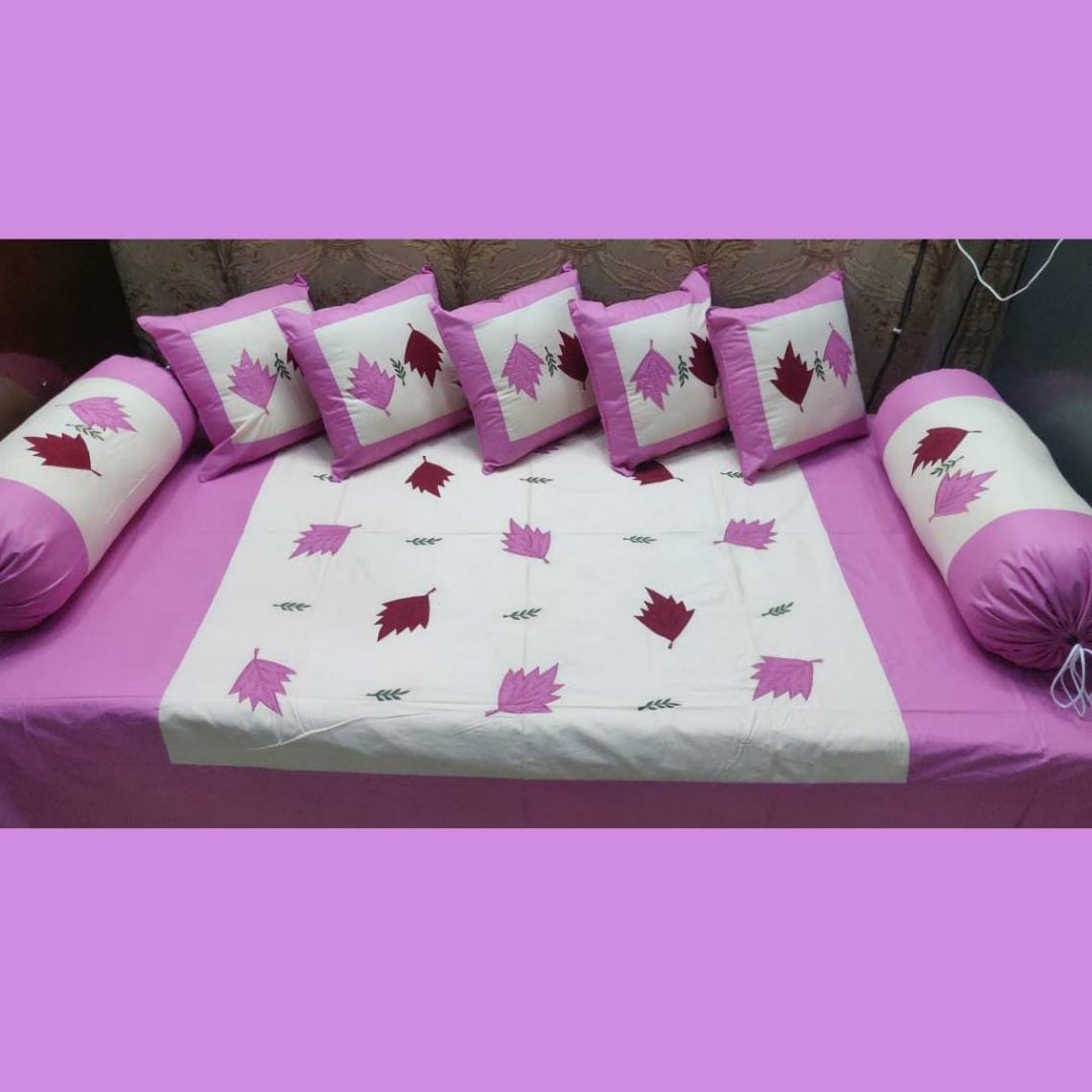 Designer-cotton-diwan-set-fuchsia-pink-embroidered-with-five-cushion-cover-and-two-booster-cover-placed-on-bedsheet-in-organized-manner