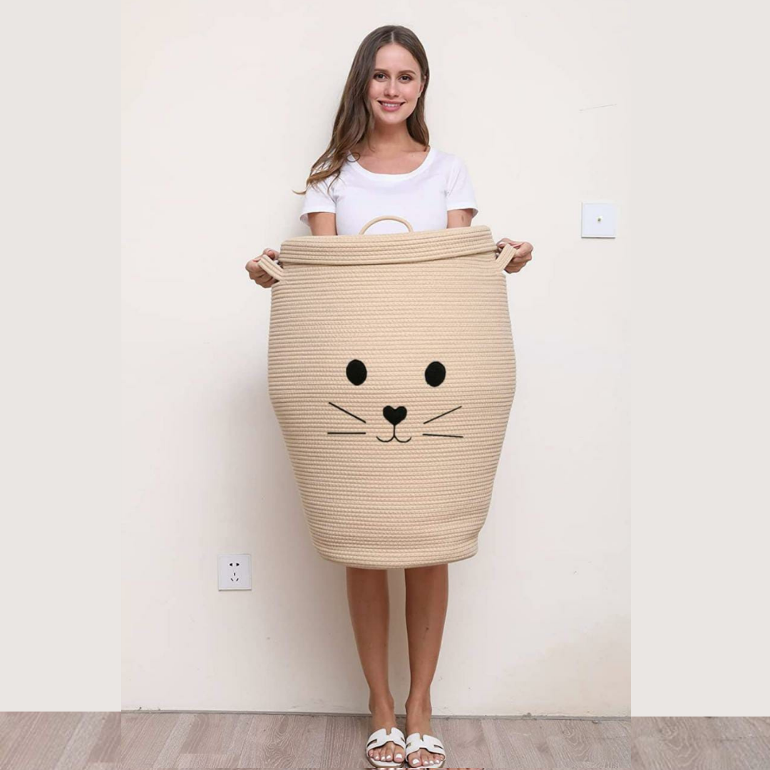 Cat-face-storage-basket-with-lid-in-Beige-color-woman-carrying-it-with-strong-handles-background
