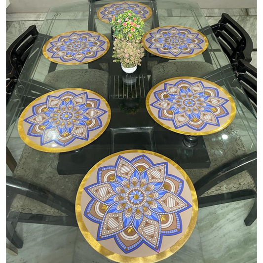 rangoli designed dining mats set of 6 placed on glass dining table floral rangoli design in blue brown color