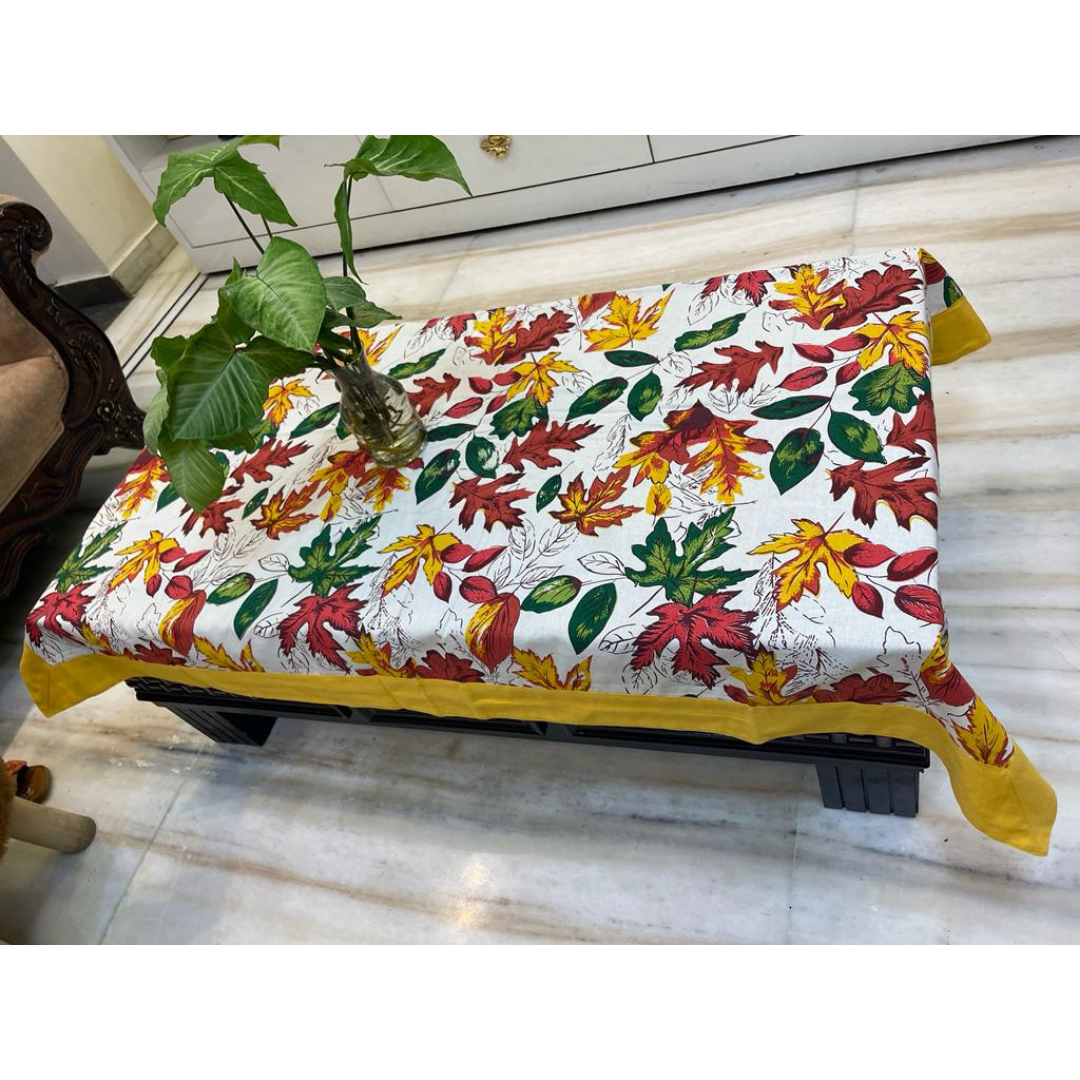 Loomsmith-floral-printed-cotton-fabric-table-cover-with-yellow-border-plant-placed-on-the-table