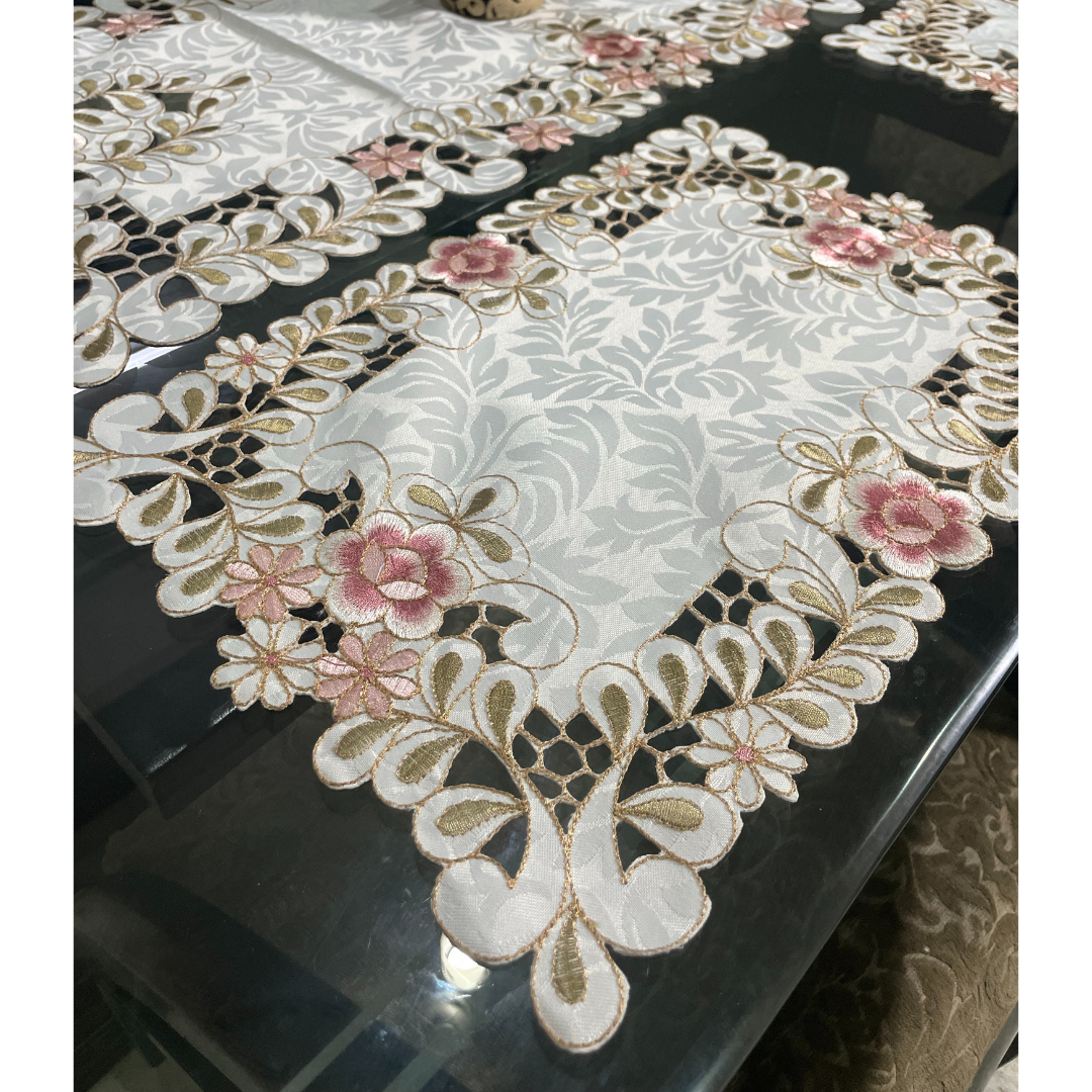 light pink floral tissue dining placemats & runner on glass dining table borders designed with cutwork pattern floral embroidered dining mats for 6 seater dining table close view
