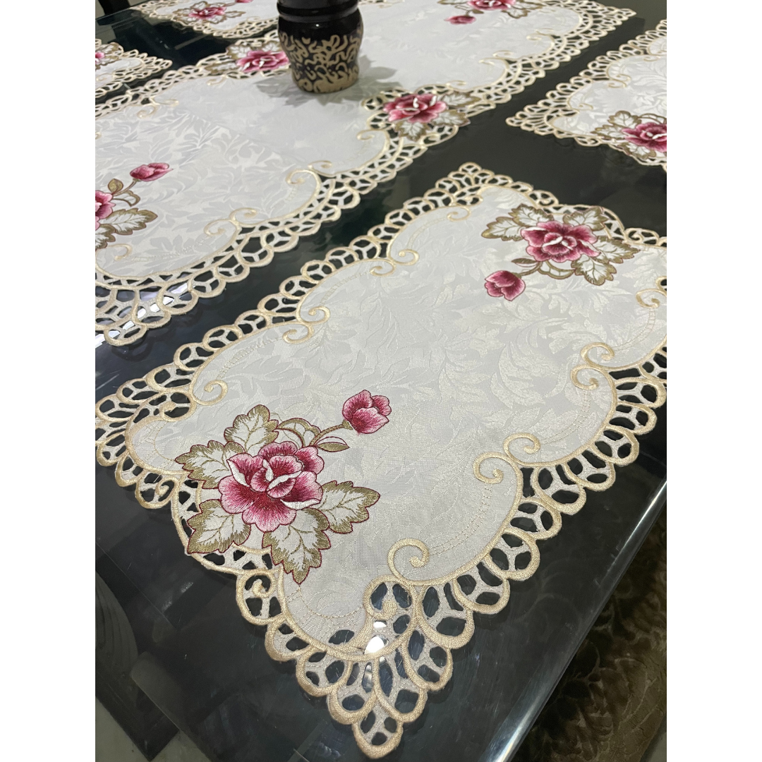 tissue dining placemats & runner on glass dining table borders designed with cutwork pattern floral embroidered dining mats for 6 seater dining table close view