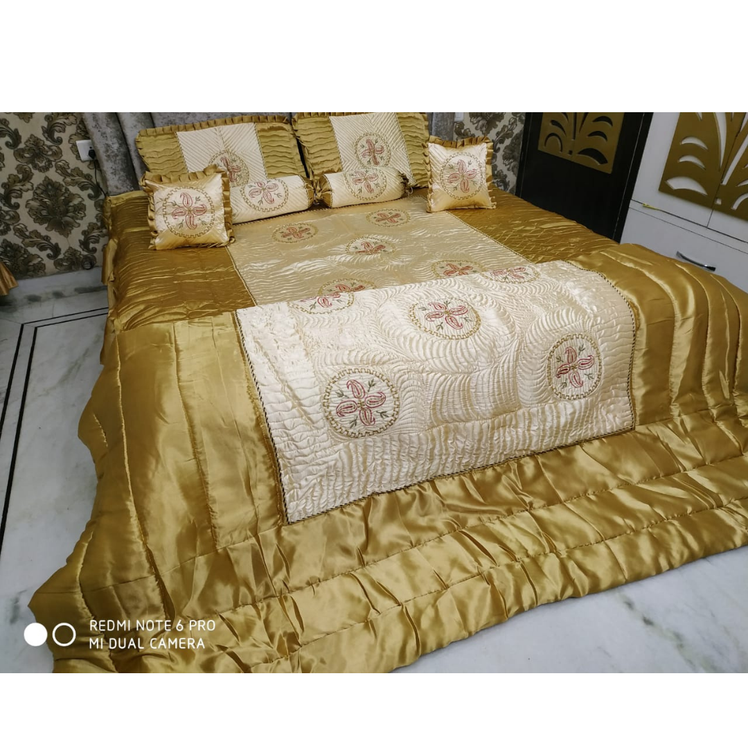 Loomsmith-satin-wedding-bedsheet-8pcs-set-king-size-gold-colour-two-pillow-two-bolster-two-cushions-one-quilt-and-one-bedsheet-pillows-cushions-quilt-are-placed-on-bed-with-