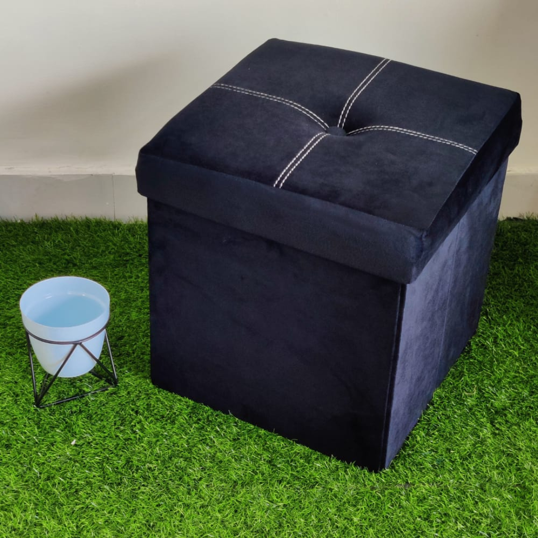 solid black color velvet storage box with stool foam sitting small pot placed near stool on faux grass floor