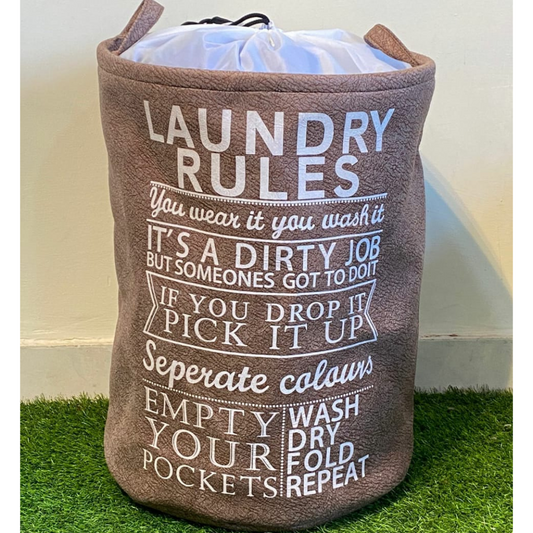 Printed-Laundry-Basket-in-Camel-color-with-drawstring-closure-placed-on-green-faux-floor