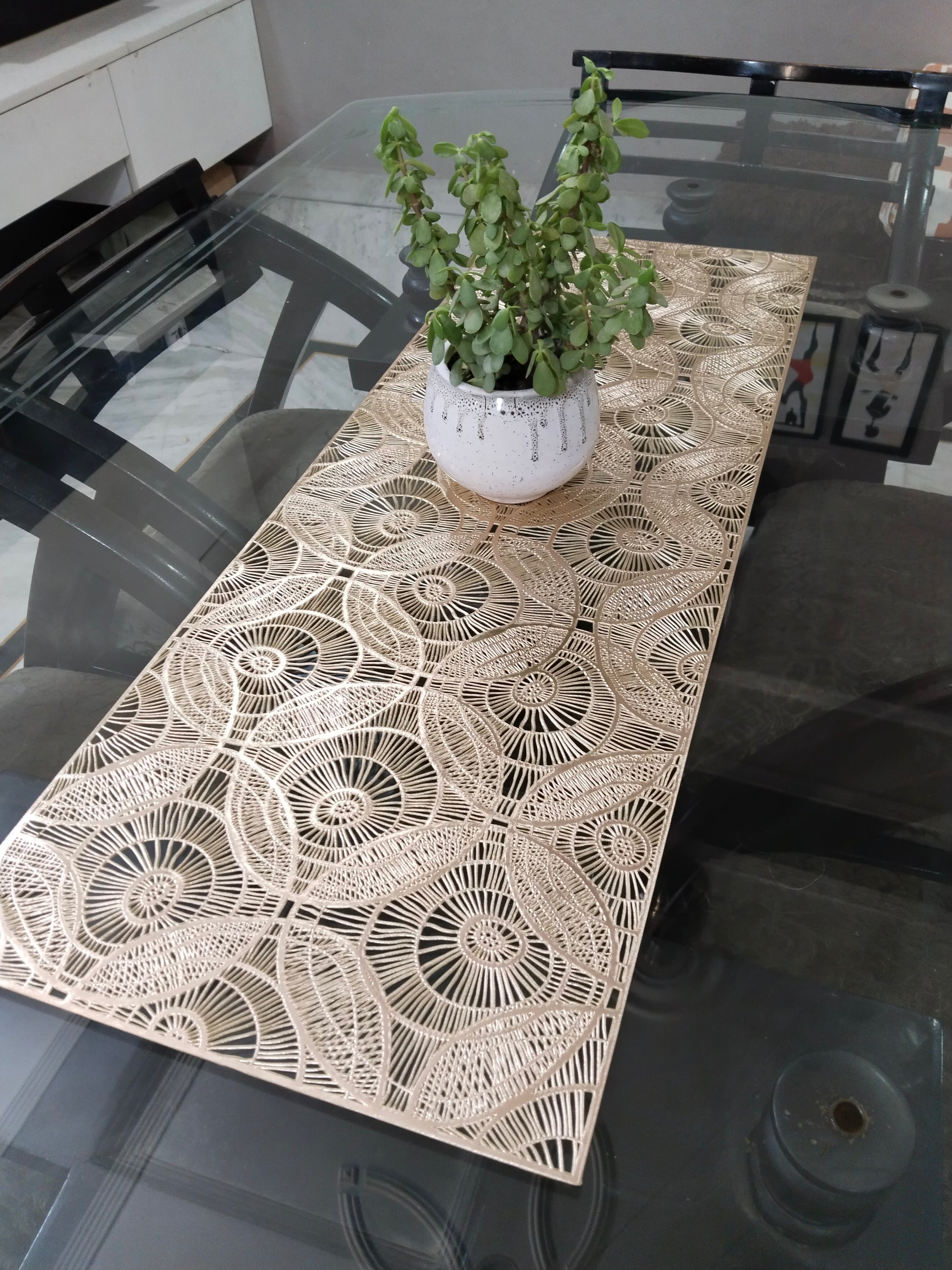 Geometric Style rectangular table placed on  a glass table runner With a plant place on top of it