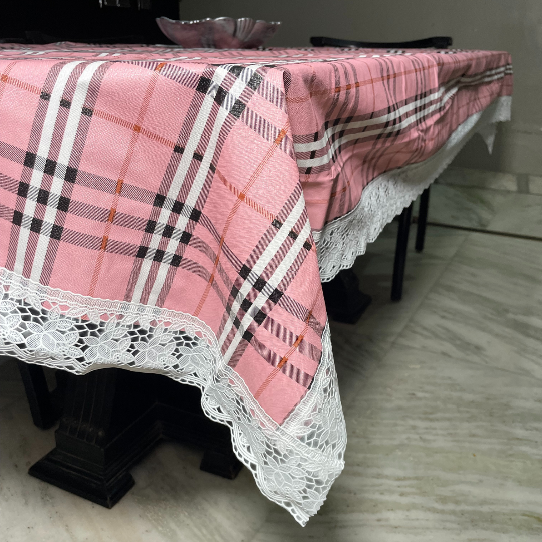 pink color burberry table cover for 6 seater dining table check printed design close view floral lace design