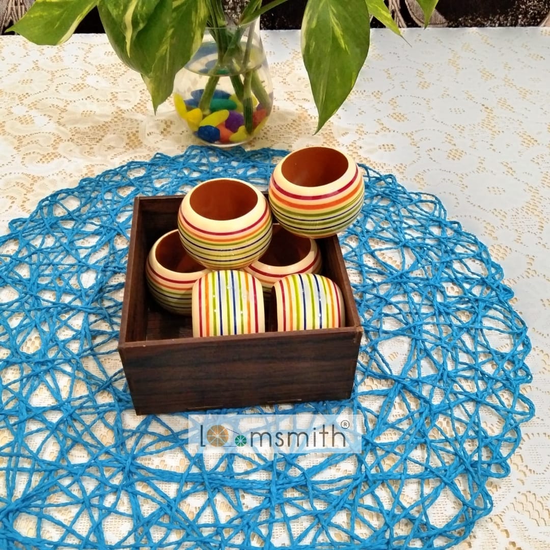 six wooden rings of yellow color is placed in a box lying on the table