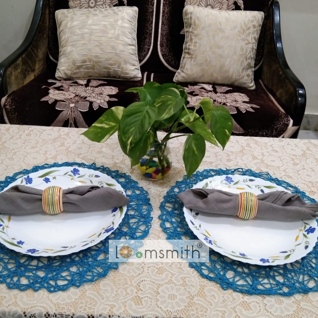 Two wooden rings in yellow colo placed on the dishes with napkins holding on the table