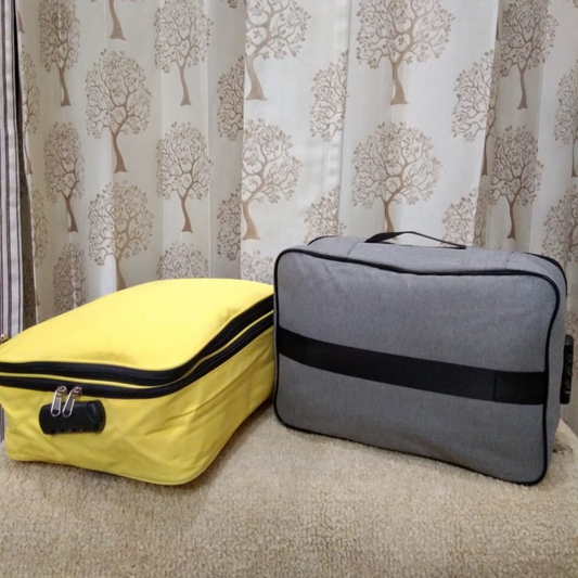 document bag organizer with four layer safe lock  available in two colors yellow and grey with zipper lying together on couch