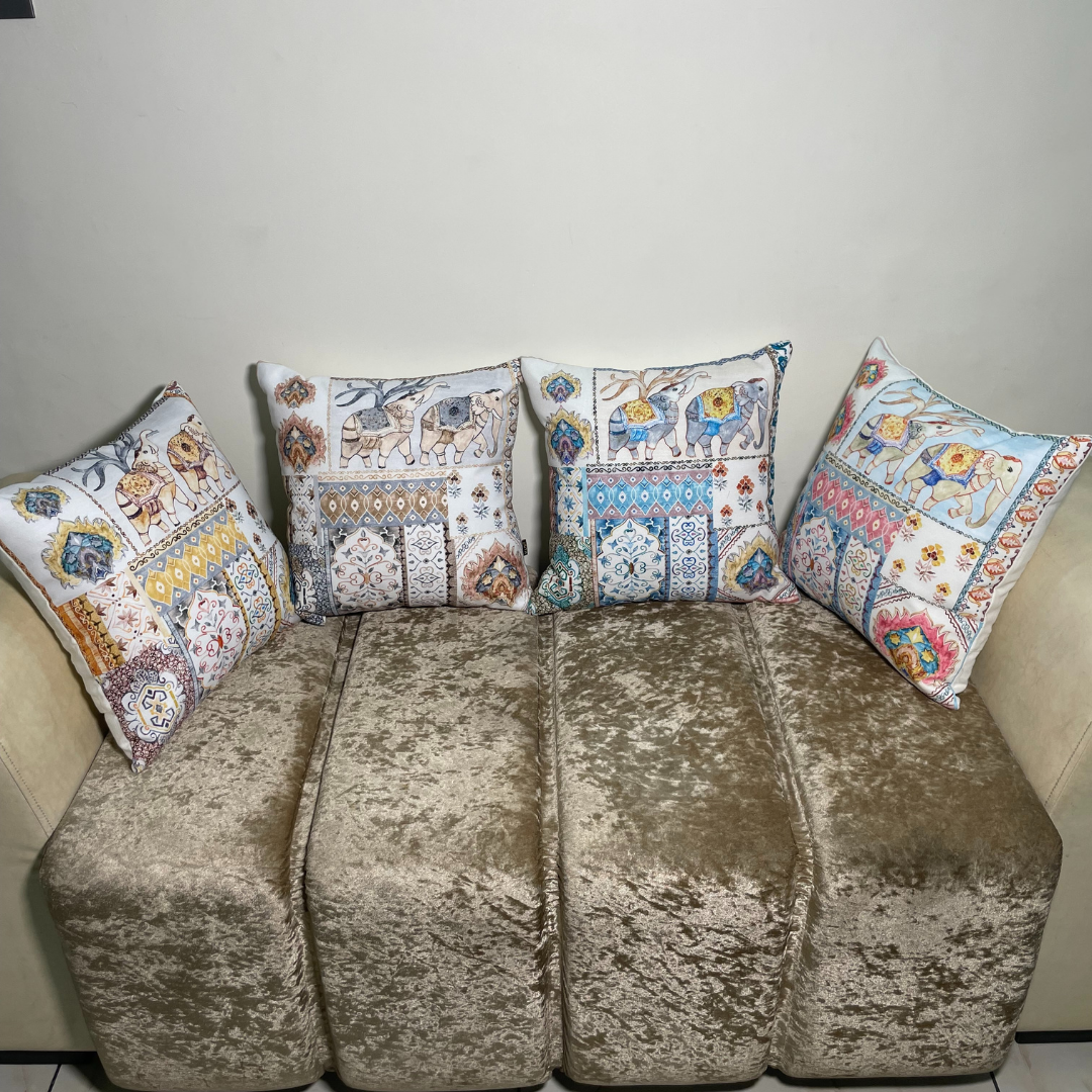 elephant printed cushion covers of cotton fabric lies on sofa in four different colors