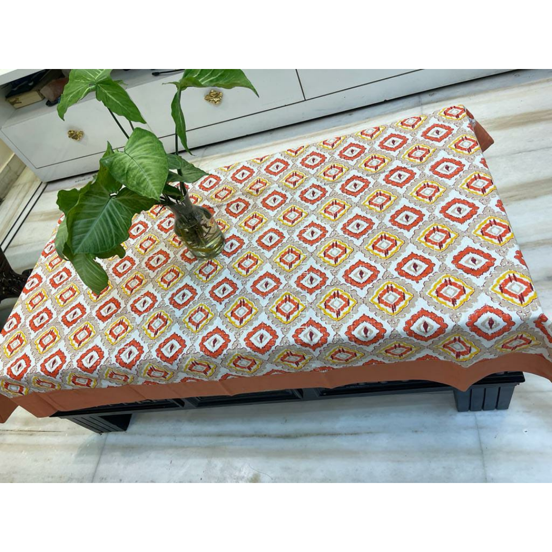 Loomsmith-floral-printed-cotton-fabric-table-cover-with-peach-colour-border-plant-placed-on-the-table