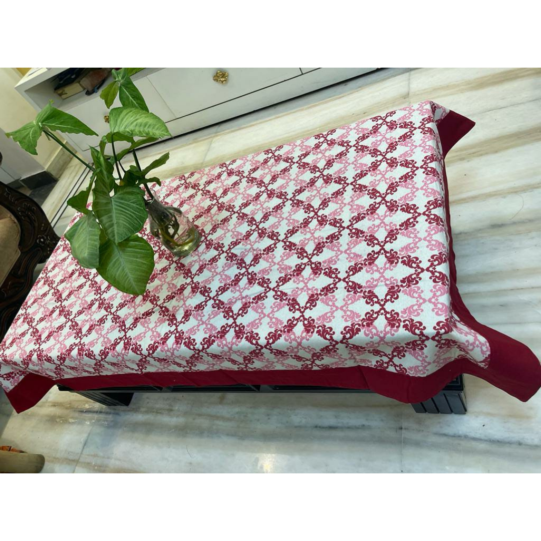 Loomsmith-floral-printed-cotton-fabric-table-cover-with-red-border-plant-placed-on-the-table