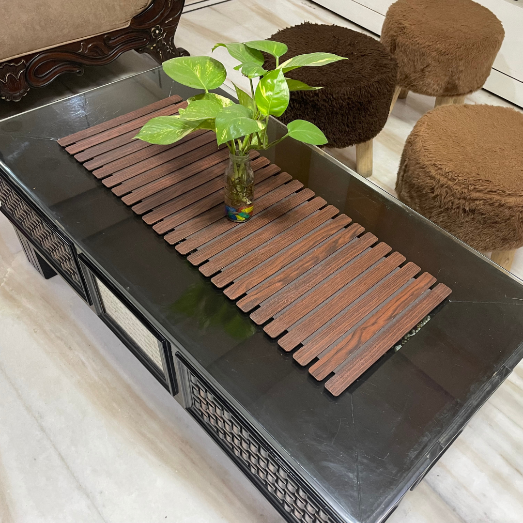 loomsmith-foldable-wooden-table-runner-for-center-table-in-coffee-color-placed-on-table-with-plant-vase-on-it