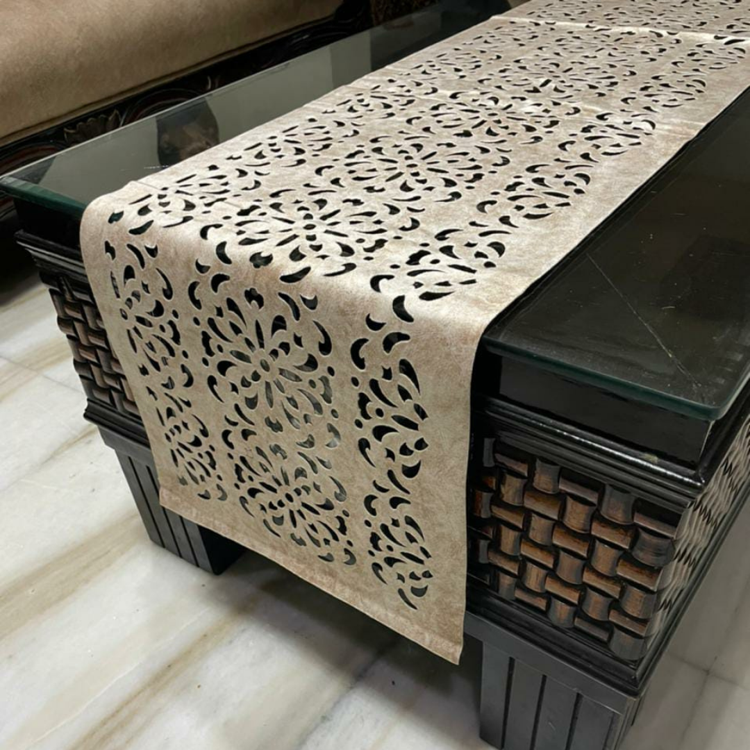 velvet table runner with floral laser cut design in cream color is placed on the black glass table side zoom view