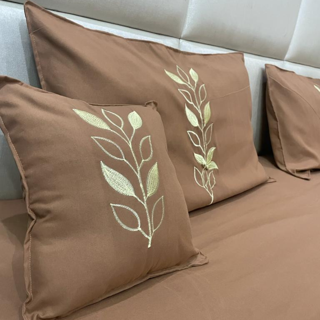 close view of cushion and pillow embroidery of brown color glace cotton bedsheet set of 5