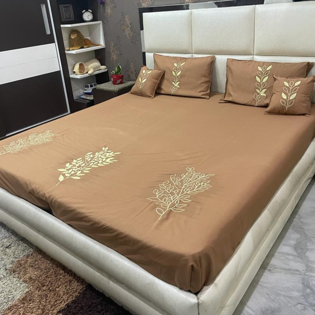 brown color glace cotton bedsheet with embroidery design on bedsheet, filled cushions and pillow covers bedding set