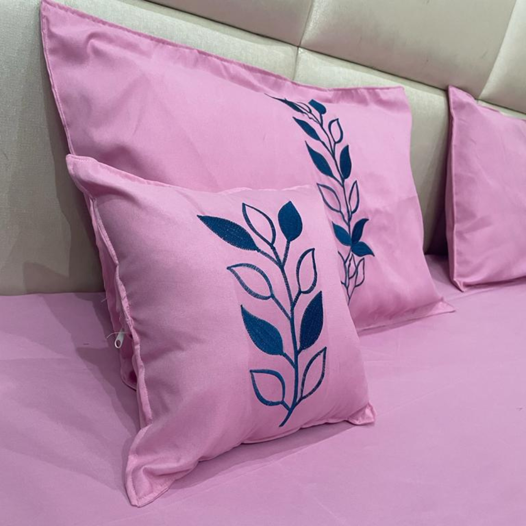 close view of cushion and pillow embroidery of pink color glace cotton bedsheet set of 5