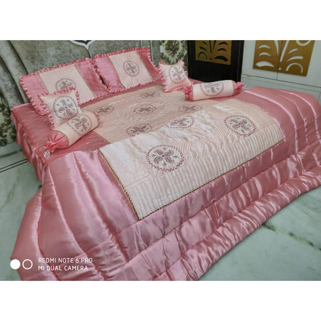 Loomsmith-satin-wedding-bedsheet-8pcs-set-king-size-baby-pink-colour-two-pillow-two-bolster-two-cushions-one-quilt-and-one-bedsheet-pillows-cushions-quilt-are-placed-on-bed-with-