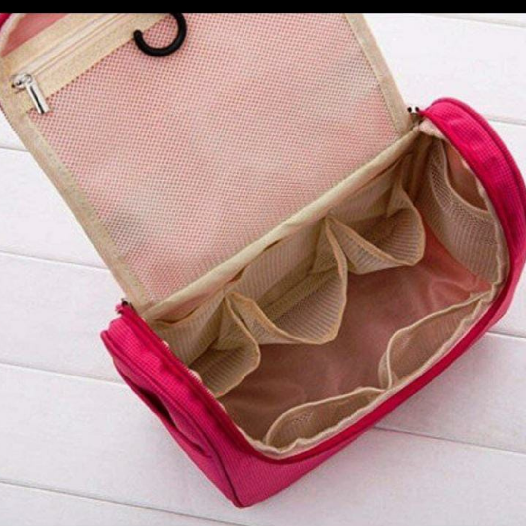 Pink toiletry bag with multi-compartments inside to keep cosmetics organized 
