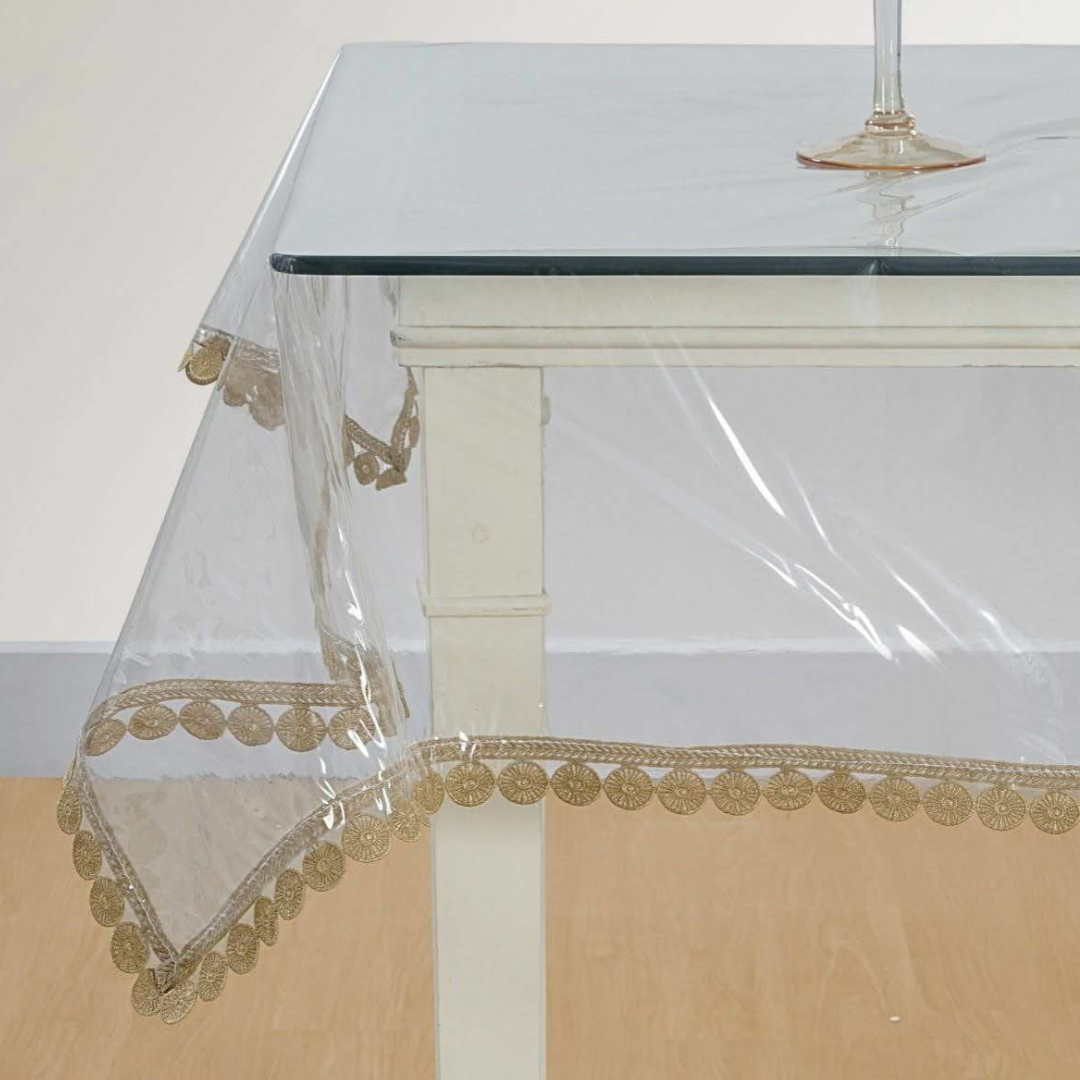 transparent table cover decorated with brown color designer lace placed on glass table