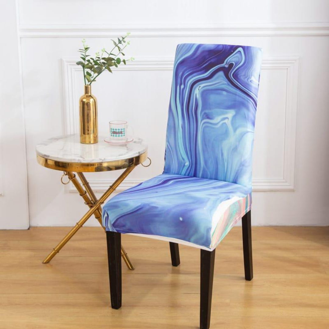 stretchable chair cover in blue shades wavy pattern placed near gold marble table