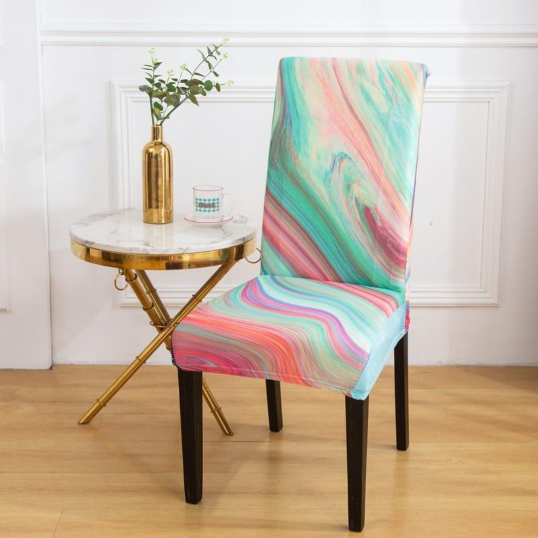 stretchable chair cover in light and pink color with wavy print placed near marble table
