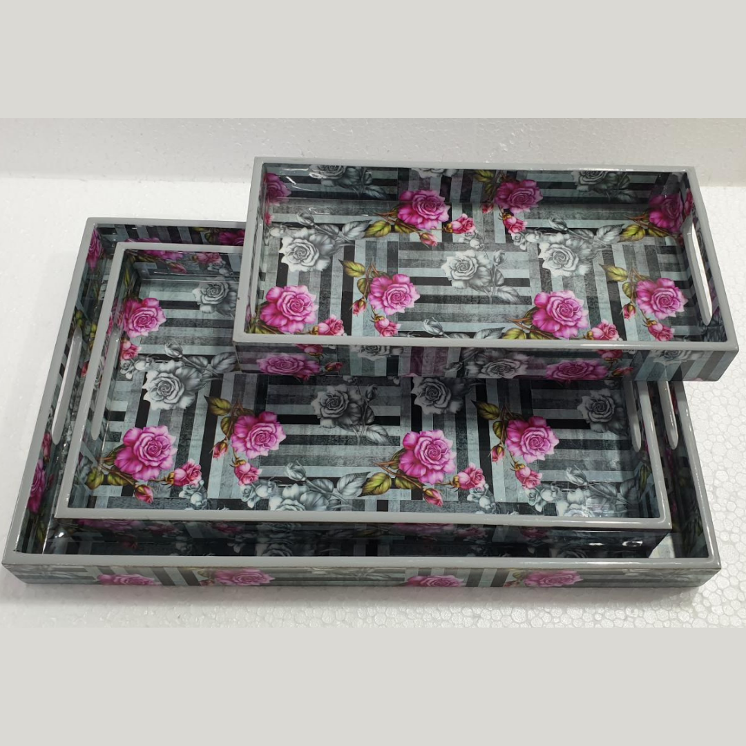 Loomsmith-wooden-tray-set-of-3-with-dark-grey-shades-lines-pattern-with-dark-pink-and-light-grey-flower-printed-lying-on-the-table-trays-are-in-three-different-sizes