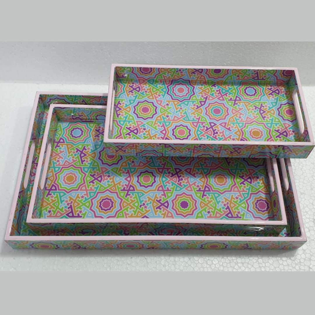 Loomsmith-wooden-tray-set-of-3-with-multicolored-geometric-pattern-lying-on-the-table-trays-are-in-three-different-sizes