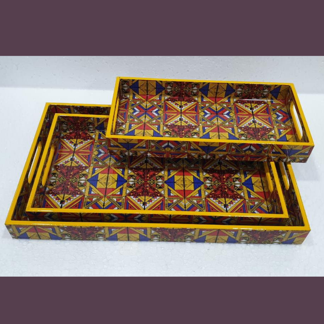 Loomsmith-wooden-tray-set-of-3-with-multicolored-geometric-pattern-mustard-colored-lying-on-the-table-trays-are-in-three-different-sizes