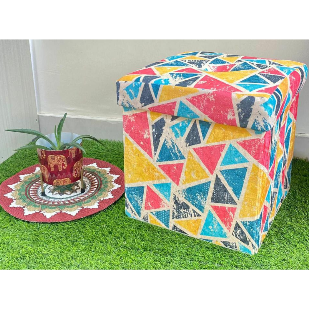 abstract printed pink color stool with storage placed on grass floor near small elephant printed pot
