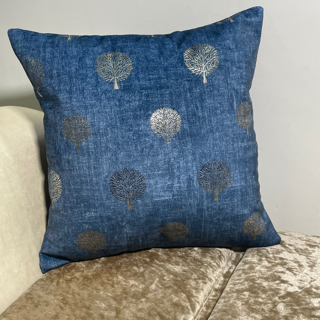 blue cushion cover in velvet fabric tree printed with foil material cushion placed on couch