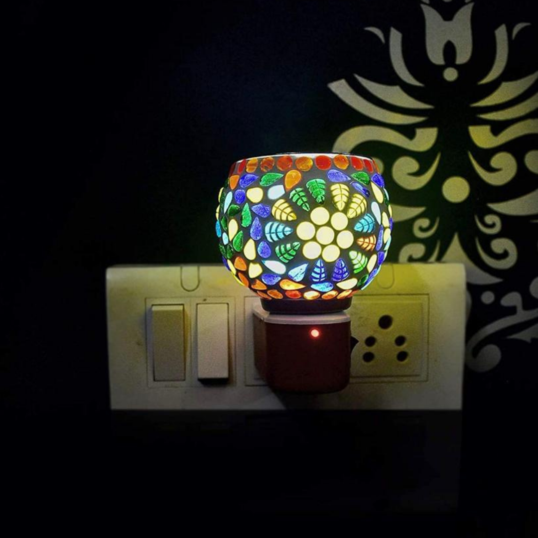Platinum-aroma-burner-with-on-off-button-plugged-in-lightning-the-room-flowers-and-leaves-on-it-in-different-colours