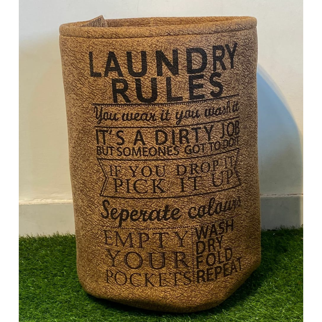 printed laundry basket in brown color with drawstring closure placed on green faux floor