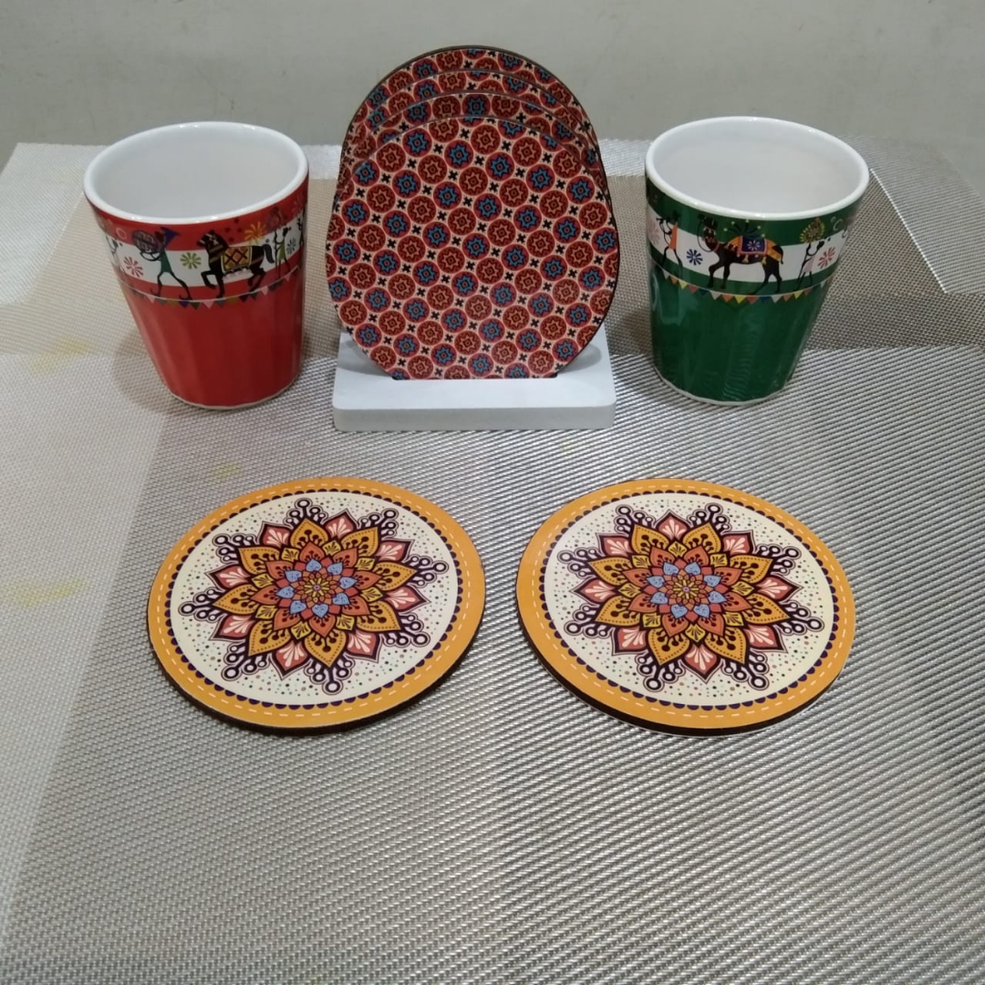 loomsmith-reversible-circular-wooden-coaster-geometric-print-set-of-six-with-stand-placed-on-table-with-glasses-orange-color